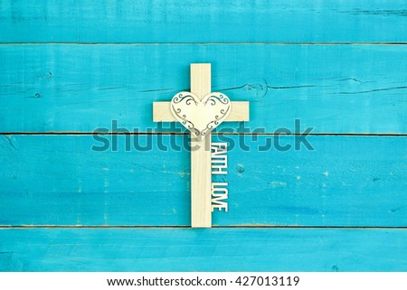 Wood cross with lace heart, FAITH and LOVE on antique rustic teal blue wood background