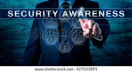 Industry consultant is pressing SECURITY AWARENESS on an interactive touch screen interface. Information technology concept for both computer or cyber security and physical asset protection. Royalty-Free Stock Photo #427033891