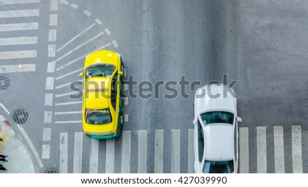 Busy city car are passing pedestrian crossing on traffic road (Aerial photo, top view)