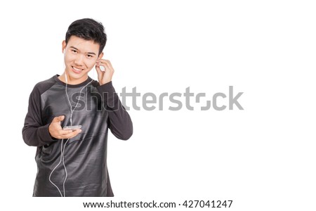 A boy in black shirt listens to music.