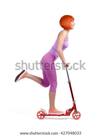 Young girl on a skateboard scooter isolated on white background
