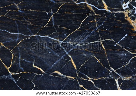 Gold yellow patterned natural in dark gray marble texture for design. Royalty-Free Stock Photo #427050667