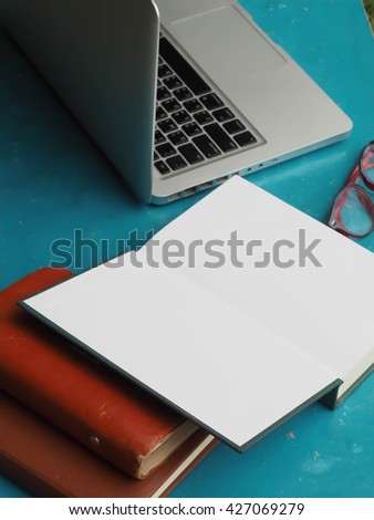 Mix of office supplies and gadgets on a wooden table background. View from above.