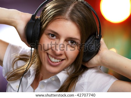 The young girl listens to music
