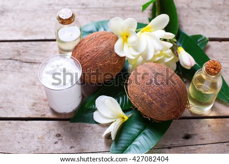 Healthy living. Coconuts,  coconut oil and milk on  vintage wooden background. Selective focus.  Natural organic spa products. 