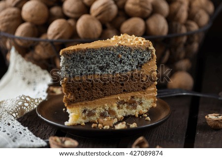 cake with nuts and poppy seeds on the background of a large basket with walnuts