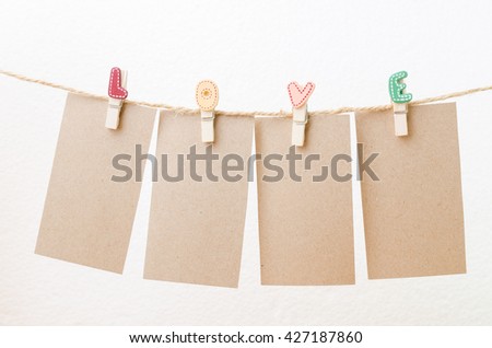 Blank paper hanging on love clothesline with white background