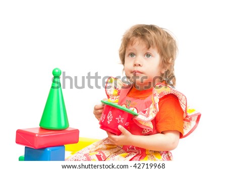 Two girls play cubes on a white background