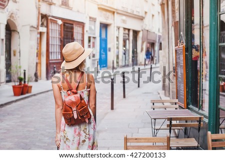 woman tourist walking on the street, summer fashion style, travel to Europe Royalty-Free Stock Photo #427200133