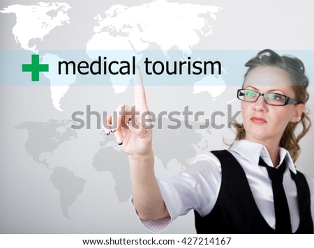 medical tourism written on a virtual screen. Internet technologies in business and tourism. woman in business suit and tie, presses a finger on a virtual screen