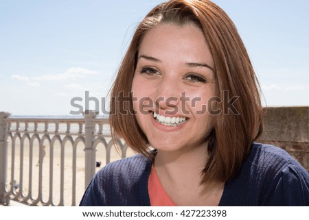 Young woman on holiday sitting on spring Beach