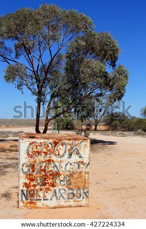 Grungy signboard of village Cook on the Nullarbor Plain, Australia. The Indian Pacific train stops at the train station of this ghost town where only five people still live. 