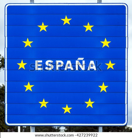 blue road sign with yellow stars in the border area between Spain and other country