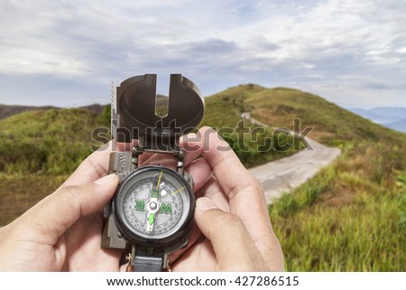 compass in the hand , in forest background