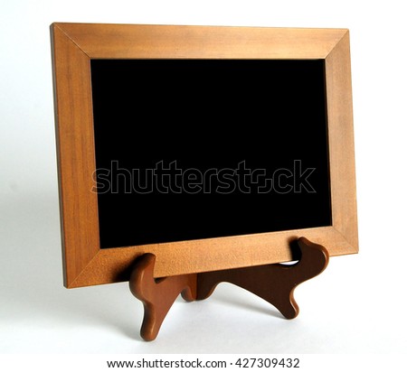 Wooden stand with wooden picture frame with shadows