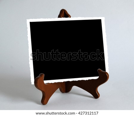 Photo shows a wooden stand with photo paper card