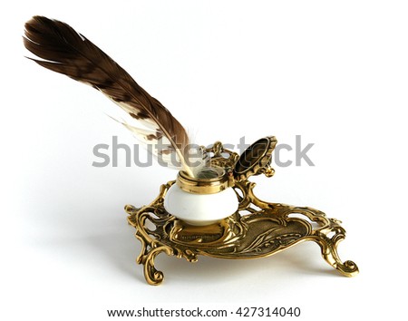 Photo shows Ornate antique brass inkwell with feather                                Royalty-Free Stock Photo #427314040