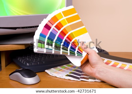 Designer at work. Color samples on table.