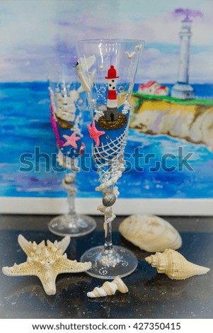 Polymer clay  decorated wedding  wineglasses with polymer clay ship, starfish, sea, Lighthouse, octopus tentacles, network with shells and marine theme picture background