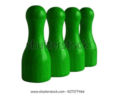 Photo shows four green wooden bowling pins isolated on white 