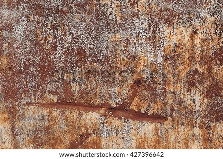 Rusty metal surface with old paint and scratches. Background and texture for design.