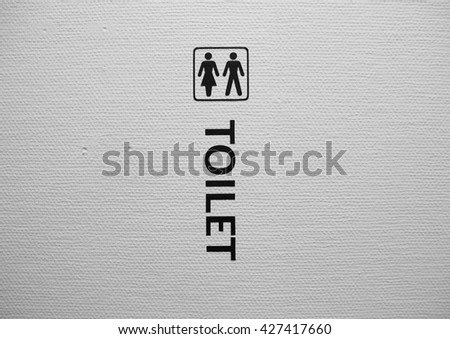 Man and Woman Toilet Sign on White Structured Wall