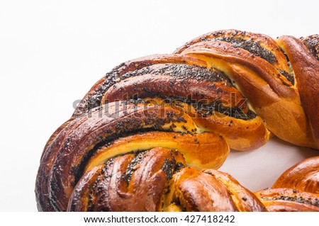 braided poppy seed round loaf on white background