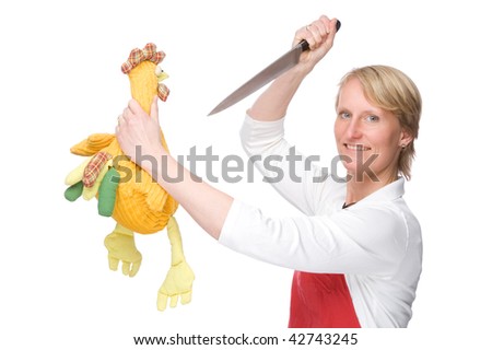 Full isolated studio picture from a young cook with knife and chicken