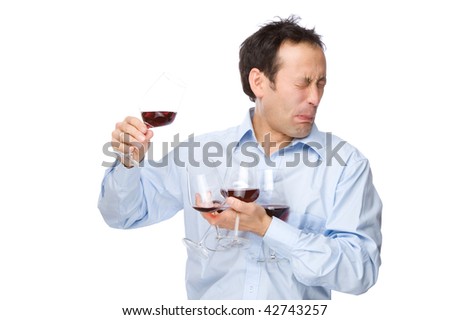Full isolated studio picture from a man tasting some wine