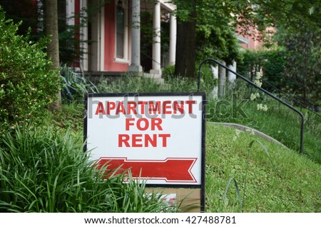 Apartment for rent sign displayed on residental street. Shows demand for housing, rental market, landlord-tenant relations. Royalty-Free Stock Photo #427488781