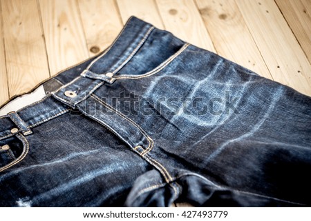 Jeans on a wooden floor Customize the colors dark tone .Meaning rock and roll style