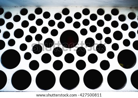 Concrete wall with large black holes like cheese rings. It can be used as a texture background, to work in the graphic editors, to create page design Landing web site.