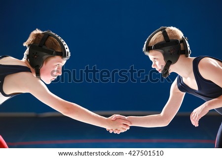 Youth wrestling partners shaking hands