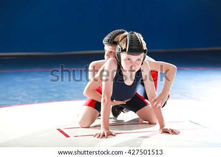 Youth wrestlers starting in the top and bottom positions