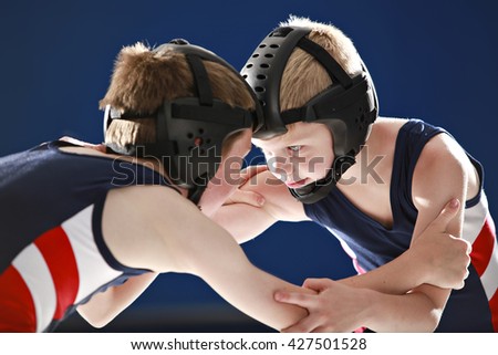 Youth wrestlers hand fighting on their feet