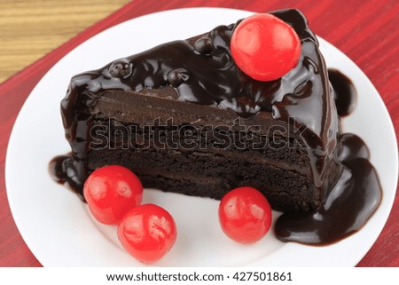 Delicious chocolate cake on plate on woodentable 