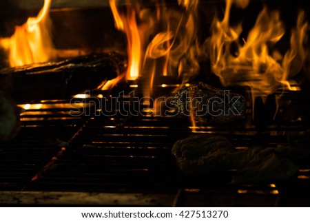 Seafood on grill  with flames of fire 