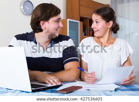 man and woman with notebook signing insurance contract