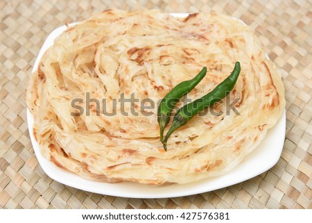 Kerala porotta / paratha / roti / naan , layered flatbread from South India ,  famous breakfast dish . Indian food culture .