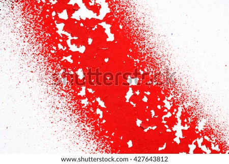 A spray of red  paint on the wall. Colored textured background.