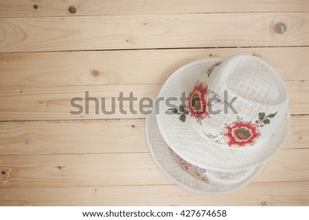 Brown straw hat On top wooden floor background / top view picture