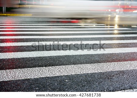 Artistic style - Crosswalk and pedestrian at modern city zebra crossing street in rainy day. Blur abstract.Background concept.