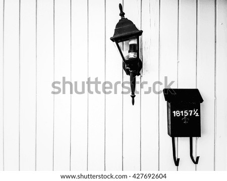 Outdoor lighting and mail box with wood wall in black and white