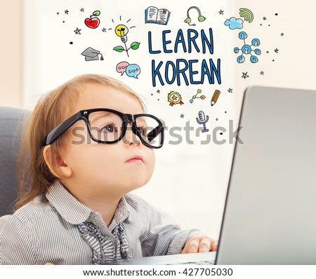 Learn Korean concept with toddler girl using her laptop