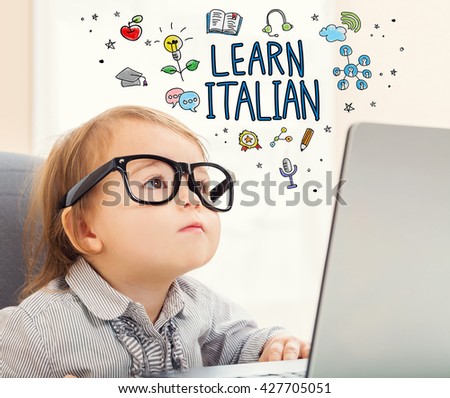 Learn Italian concept with toddler girl using her laptop