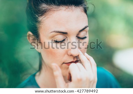 Breathing exercise Pranayama - Alternate nostril breathing, often performed for stress and anxiety relief Royalty-Free Stock Photo #427789492