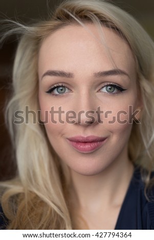 Portrait of beautiful blonde girl taking selfie.