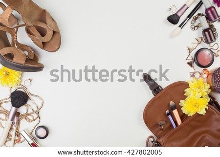 Women's accessories and cosmetics. Top view photo of colorful and glamour objects with free space for logo. There are shoes and perse