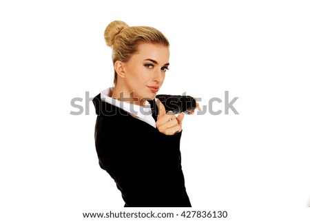 Young businesswoman pointing at something