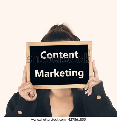 Business women show blackboard with message content marketing